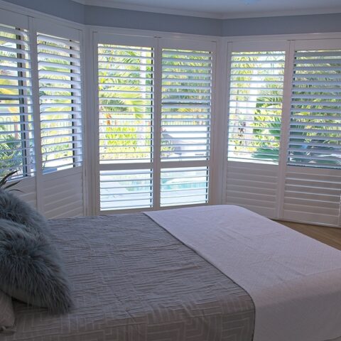 Luxury white indoor plantation shutters In a Geelong bedroom
